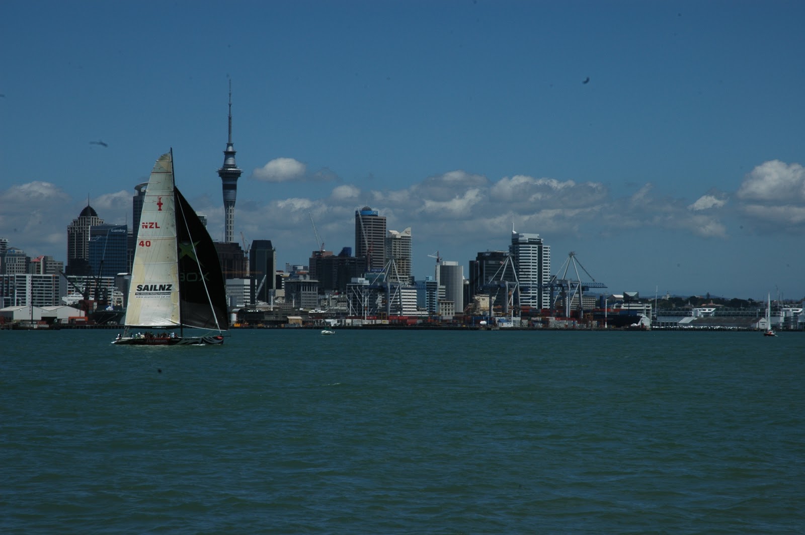 NZL40 cruising in front of Auckland Harbor